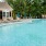 a swimming pool with chairs and umbrellas