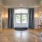 a large room glass doors and white pillars