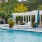 a pool with a gazebo and chairs around it
